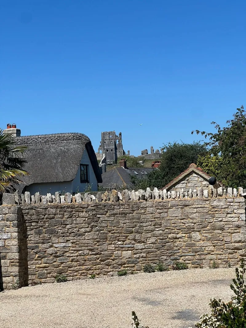 Corfe Castle ruins above village rooftops, seen while on a job