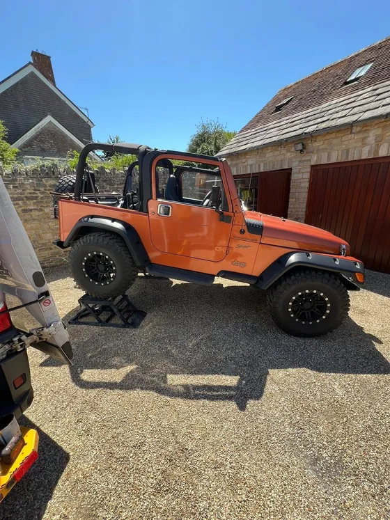 Jeep Wrangler raised on ramps on a customer's driveway